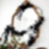 Elegant black floral garland draped across a vintage mirror